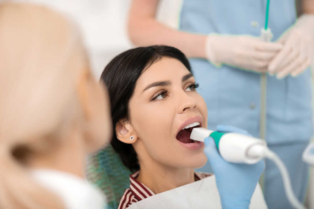 Young lady has dental treatment at Medazur Medical Clinic in Leytonstone.
