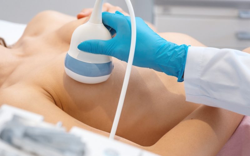 Lady having breast ultrasound machine on her breast. Medazur Medical Clinic in Leytonstone.