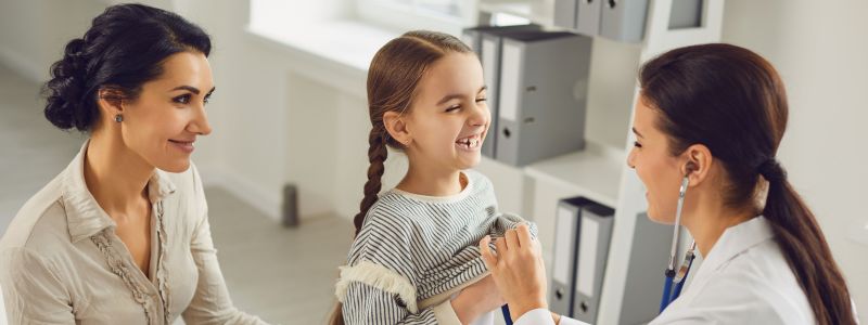 Young firl smiles to paediatrician. Medazur Medical Clinic in Leytonstone.