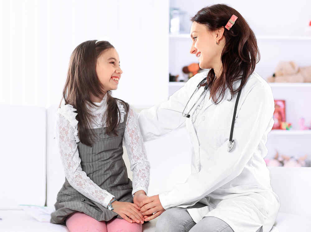 Female doctor speaks to young girl. Medazur Medical Clinic in Leytonstone.