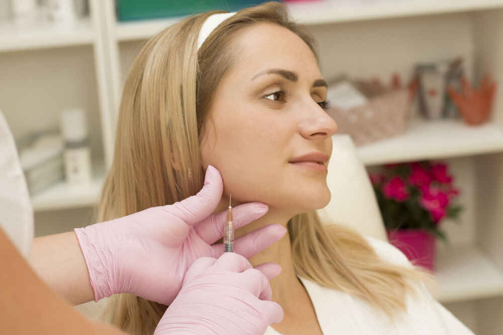 Young woman given cheek injection. Medazur Medical Clinic in Leytonstone.